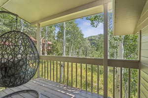 Wooden deck featuring a view of trees