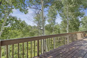 Leafy green aspen surround this cabin.