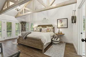 Bedroom with access to outside, wood finished floors, a chandelier, high vaulted ceiling, and beam ceiling
