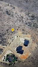 Aerial view of property and surrounding area featuring a desert landscape