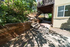 View of patio with stairs and a wooden deck