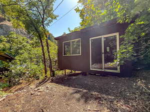 View of side of property with an outdoor structure