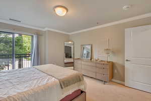 Bedroom with crown molding, light colored carpet, and access to exterior