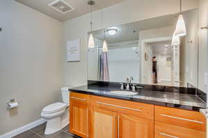 Full bathroom featuring tile patterned flooring, vanity, and a shower with curtain