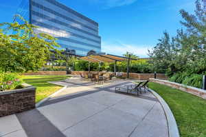 View of community with a patio, a yard, and outdoor dining space