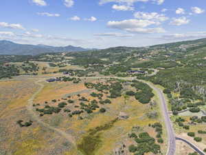 Aerial view of property's location with a mountainous background