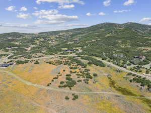 Aerial view of property and surrounding area with a mountainous background