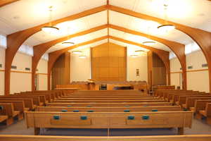 Additional view of chapel with wood pews and raised dais
