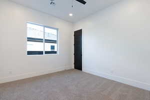 Empty room with light colored carpet, ceiling fan, and recessed lighting