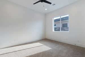 Unfurnished room featuring ceiling fan, carpet floors, and recessed lighting
