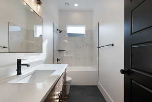 Full bath with vanity, tile patterned flooring, and  shower combination