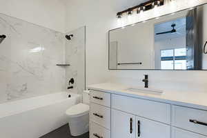 Bathroom with vanity, shower / bath combination, ceiling fan, and tile patterned floors