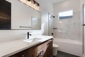 Bathroom with vanity, shower / washtub combination, and tile patterned flooring