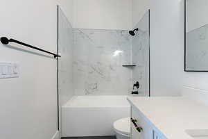 Bathroom featuring vanity and  shower combination