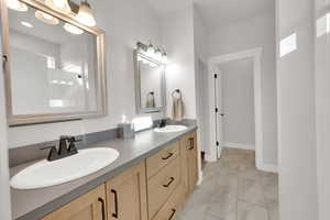 Owner's suite featuring double vanity and walk-in shower