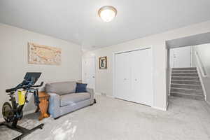 Exercise area with carpet floors and baseboards