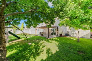 View of yard featuring a pergola, a patio, and a playground