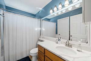 Bathroom featuring vanity and curtained shower