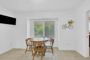 Dining area featuring crown molding and light tile patterned floors
