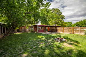 Fenced backyard with a fire pit