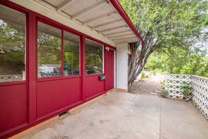 Property entrance with a patio area and brick siding
