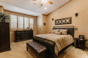 Bedroom featuring light carpet, ornamental molding, recessed lighting, and a ceiling fan