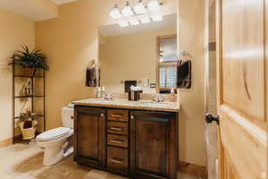 Bathroom featuring toilet and double vanity