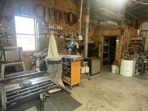 Misc room featuring a workshop area and concrete floors
