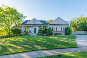Greek revival house with stucco siding, brick siding, and covered porch