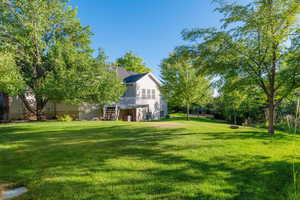 View of grassy yard with stairway