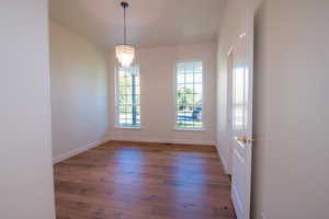 Unfurnished room featuring wood-type flooring and baseboards
