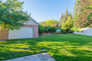 View of yard with a detached garage and an outdoor structure