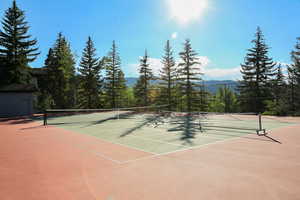 View of tennis court featuring community basketball court and a mountain view