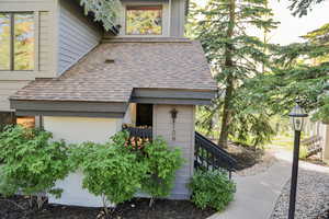 View of side of home featuring a shingled roof