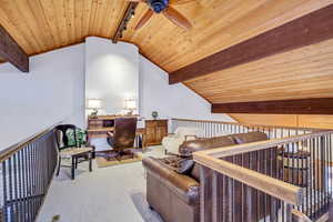 Sitting room featuring wood ceiling, a ceiling fan, carpet flooring, and rail lighting