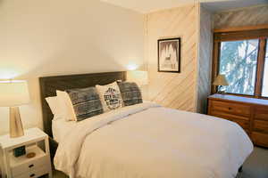Bedroom featuring wood walls