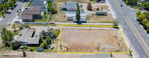 Aerial view of property's location featuring property parcel outlined and nearby suburban area