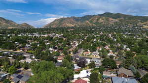 Aerial view of property's location with a mountainous background and nearby suburban area