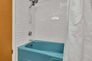 Bathroom with shower / tub combo with curtain