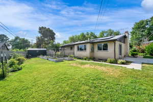 View of yard with a vegetable garden and a storage shed