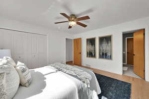 Bedroom featuring light wood-type flooring, a closet, and ceiling fan