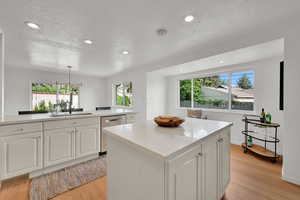 Kitchen featuring plenty of natural light, light wood-style flooring, recessed lighting, and a textured ceiling