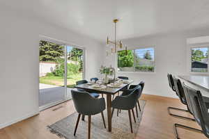 Dining room with baseboards and light wood-style flooring