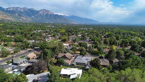 Aerial view of residential area with a forest and mountains