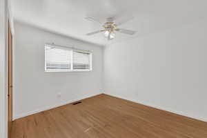 Empty room featuring light wood-style floors and ceiling fan