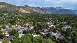 View of property location with mountains and nearby suburban area