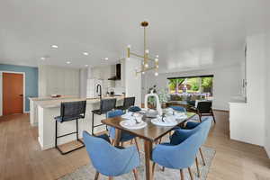 Dining area featuring light wood-style flooring and recessed lighting