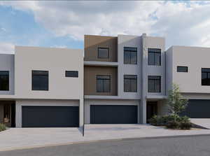 Contemporary home with stucco siding, driveway, and a garage