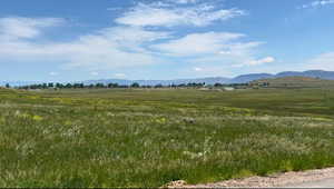 View of mountain backdrop featuring rural landscape