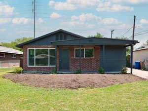 Ranch-style home featuring brick siding